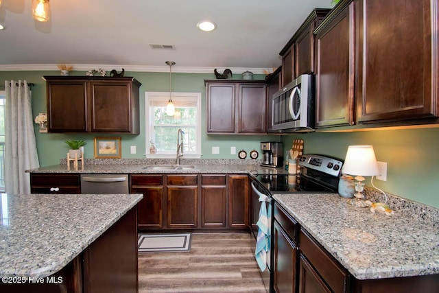 kitchen with dark brown cabinetry, sink, and appliances with stainless steel finishes