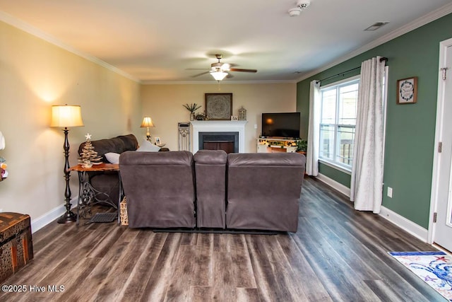 living room with ceiling fan, dark wood-type flooring, and ornamental molding