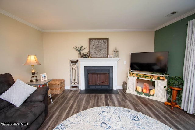 living room featuring dark hardwood / wood-style floors and crown molding