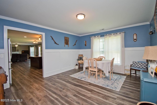 dining room featuring a wealth of natural light, ceiling fan, dark wood-type flooring, and ornamental molding