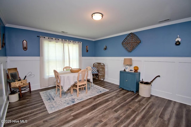 dining room with dark wood-type flooring and ornamental molding