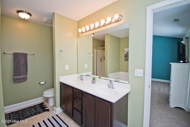 full bathroom featuring tile patterned floors, vanity, shower with separate bathtub, and toilet