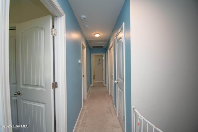 hall with light colored carpet