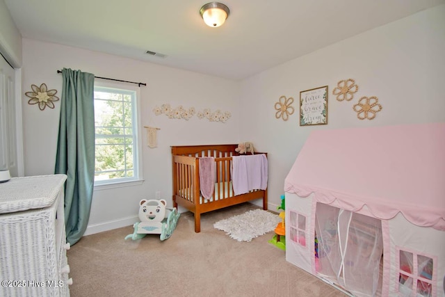 bedroom featuring a crib and carpet floors