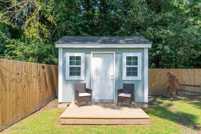 view of outbuilding featuring a lawn