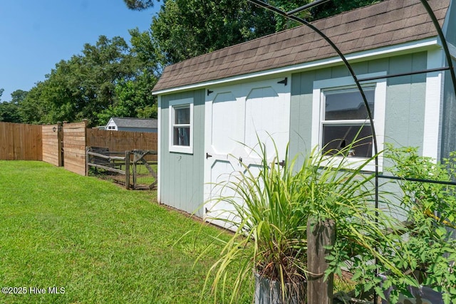 view of outbuilding with a yard