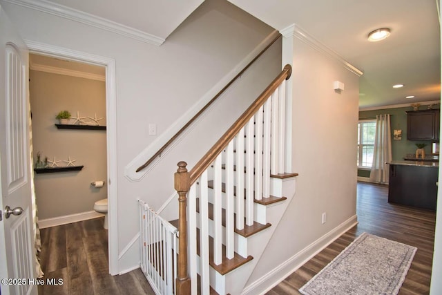 staircase with hardwood / wood-style floors and crown molding