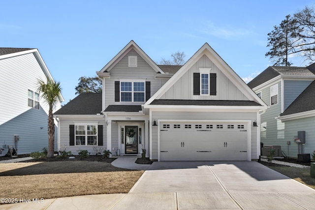 view of front of home with a garage and central air condition unit