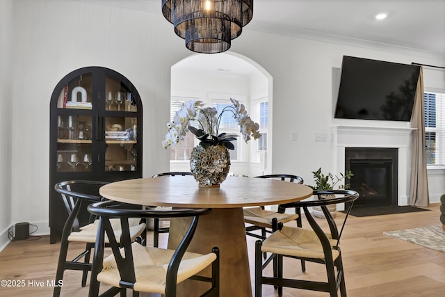 dining area featuring ornamental molding, a healthy amount of sunlight, and hardwood / wood-style floors