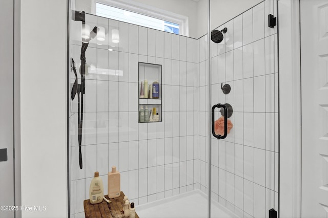 bathroom featuring a shower with door