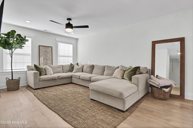 living room with hardwood / wood-style flooring and ceiling fan