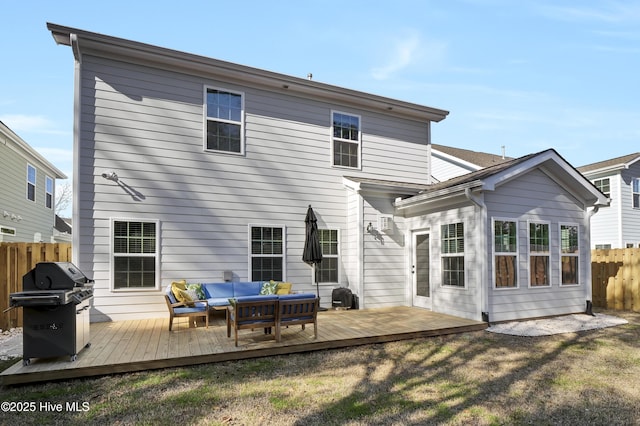 back of house with a wooden deck, an outdoor living space, and a yard