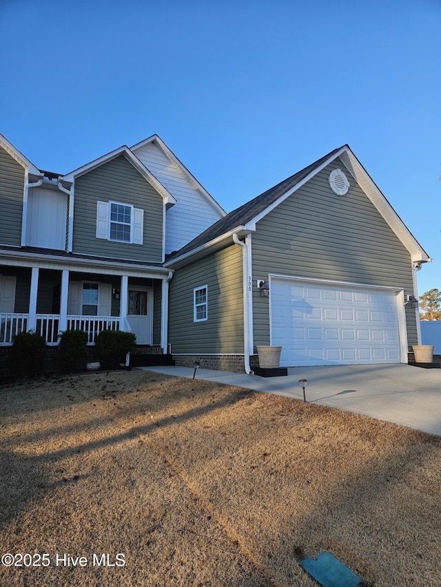 view of front of home featuring covered porch and a garage