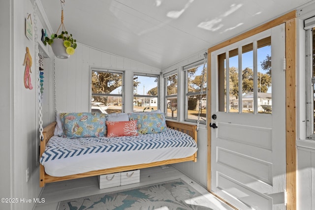 sunroom with plenty of natural light and lofted ceiling