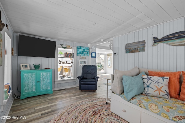 living room with wooden ceiling, wood-type flooring, and wooden walls