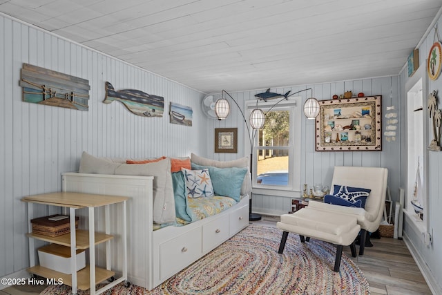 sitting room with light wood-type flooring and wooden ceiling