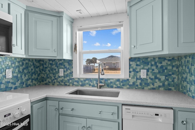 kitchen with white dishwasher, sink, backsplash, and range