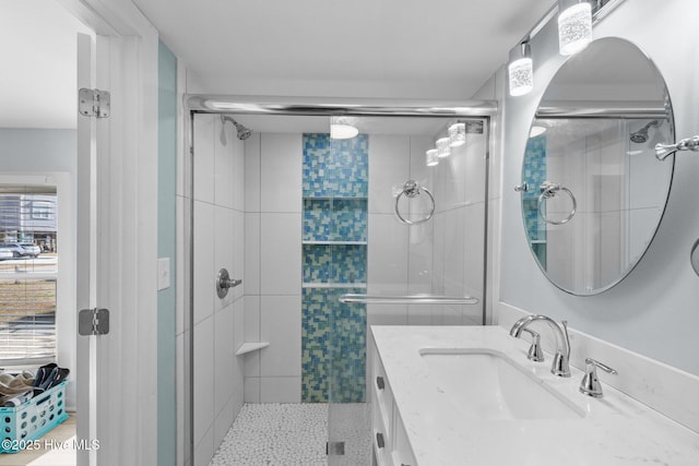 bathroom with an enclosed shower and vanity