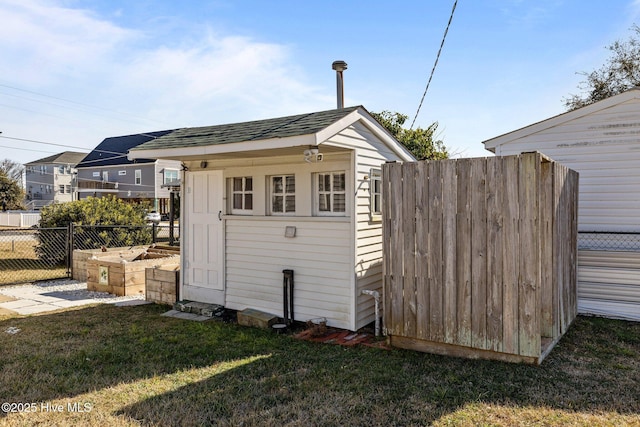 view of outdoor structure featuring a lawn