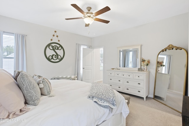 bedroom with ceiling fan and light colored carpet