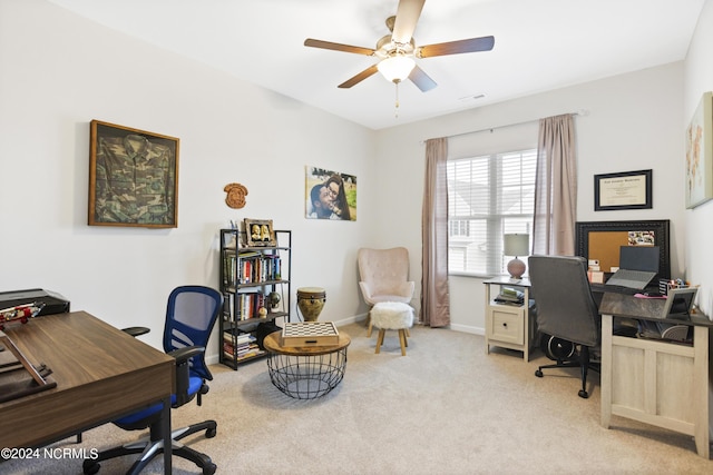 carpeted office featuring ceiling fan