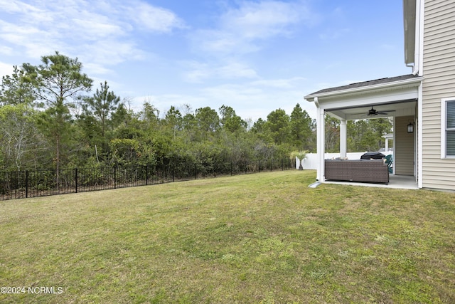 view of yard featuring an outdoor living space, a patio, and ceiling fan