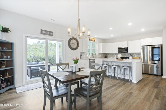 dining space featuring dark hardwood / wood-style flooring and a chandelier