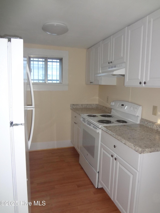 kitchen featuring white cabinets, white appliances, and light hardwood / wood-style flooring