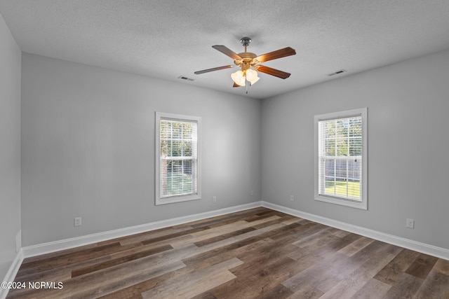 unfurnished room with a textured ceiling, ceiling fan, and dark hardwood / wood-style floors