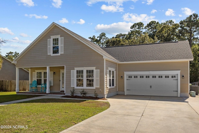 view of front facade with a porch, a garage, central air condition unit, and a front yard