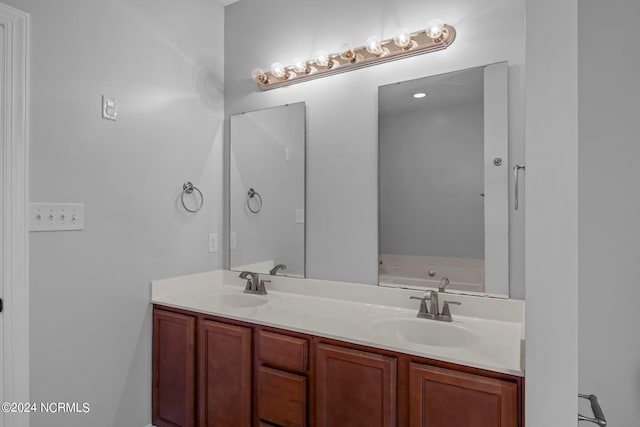 bathroom featuring a bath and vanity