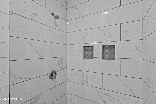 bathroom with tiled shower