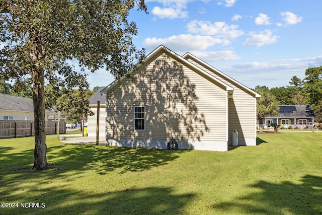 view of side of home with a lawn