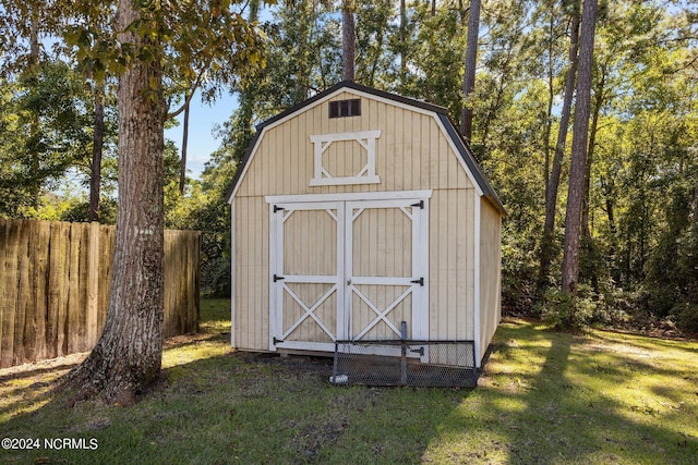 view of outbuilding featuring a lawn