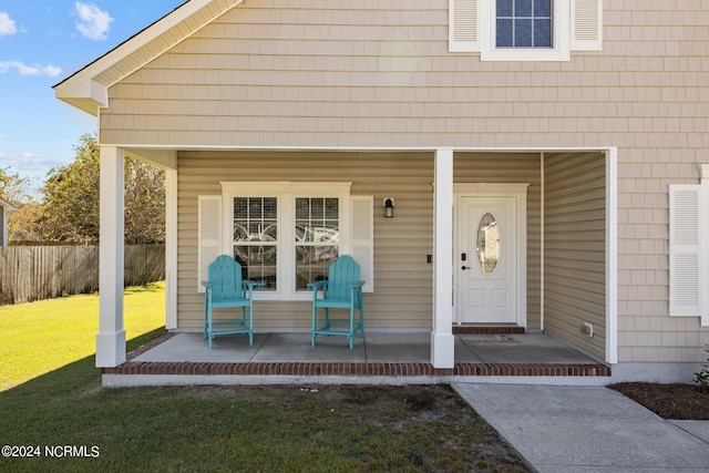 view of exterior entry with a yard