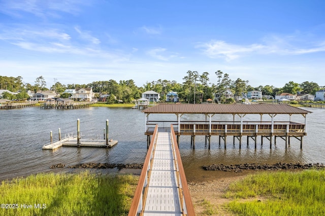 view of dock with a water view and a residential view