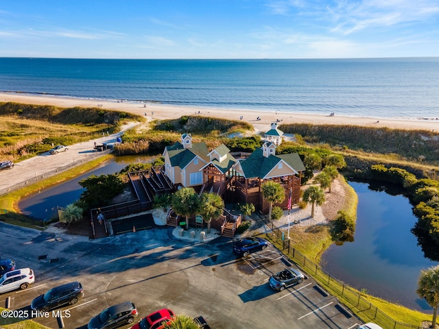 bird's eye view featuring a water view and a view of the beach