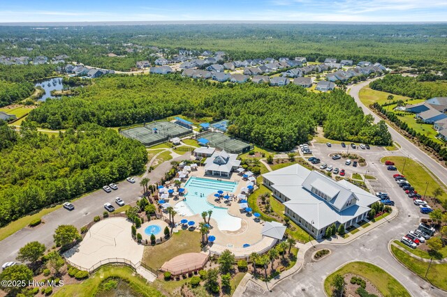 drone / aerial view featuring a residential view and a forest view