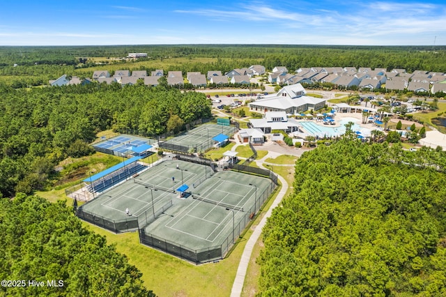 drone / aerial view with a wooded view and a residential view