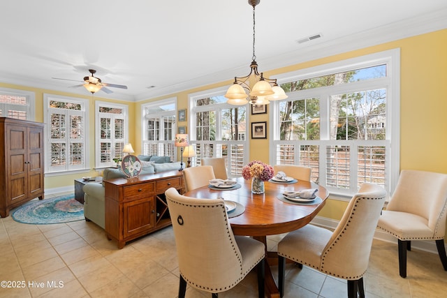 dining space featuring ceiling fan with notable chandelier, ornamental molding, and light tile patterned flooring