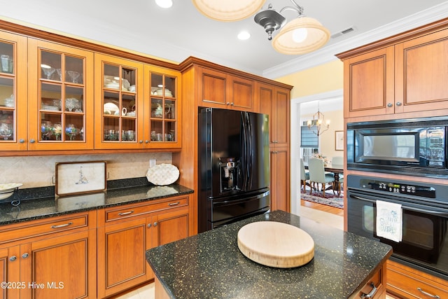 kitchen with brown cabinets, backsplash, ornamental molding, and black appliances