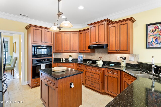 kitchen featuring pendant lighting, a kitchen bar, crown molding, and black appliances