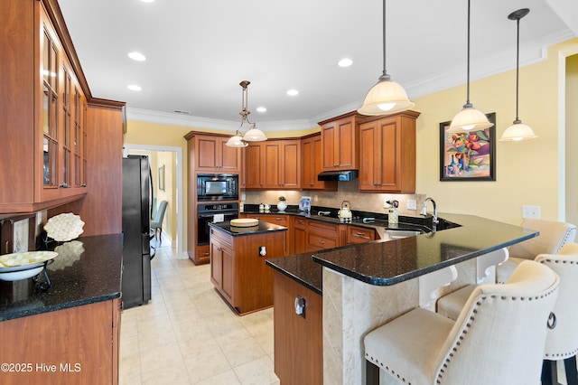 kitchen with crown molding, a peninsula, under cabinet range hood, a sink, and black appliances