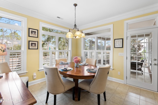 dining room featuring a healthy amount of sunlight, baseboards, a notable chandelier, and visible vents