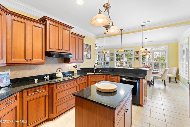 kitchen with sink, ventilation hood, black appliances, decorative light fixtures, and dark stone counters