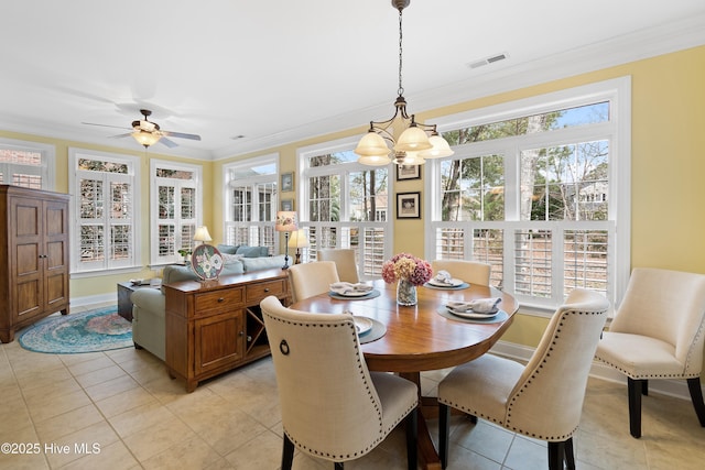 dining room with plenty of natural light, crown molding, and visible vents