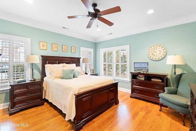 bedroom featuring crown molding, ceiling fan, and light wood-type flooring