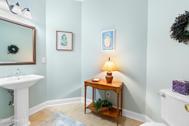 bathroom featuring tile patterned flooring, sink, and toilet