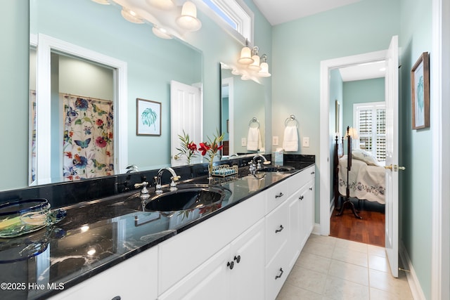 bathroom with a sink, tile patterned floors, and plenty of natural light