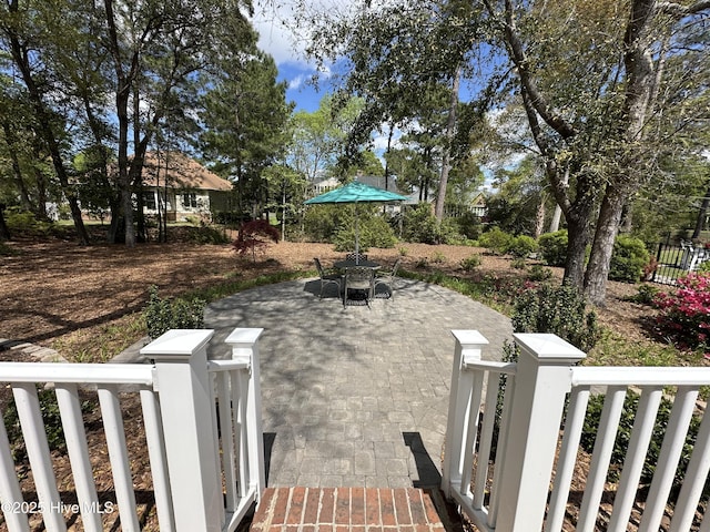 exterior space with fence, outdoor dining area, and a patio area
